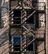 Fire Escapes, Bas relief sculted faces
