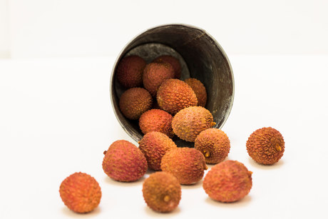 Lychees in a silver bucket.