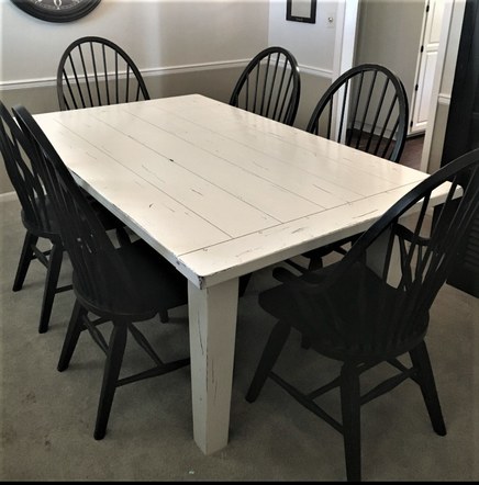 Farmhouse table repainted in creamy white and black distressing