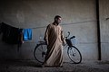 Man poses in a displaced site in Mosul, Iraq